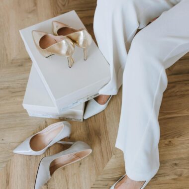 Photo by Anastasia Shuraeva Close-up of a woman trying on elegant high heels indoors.