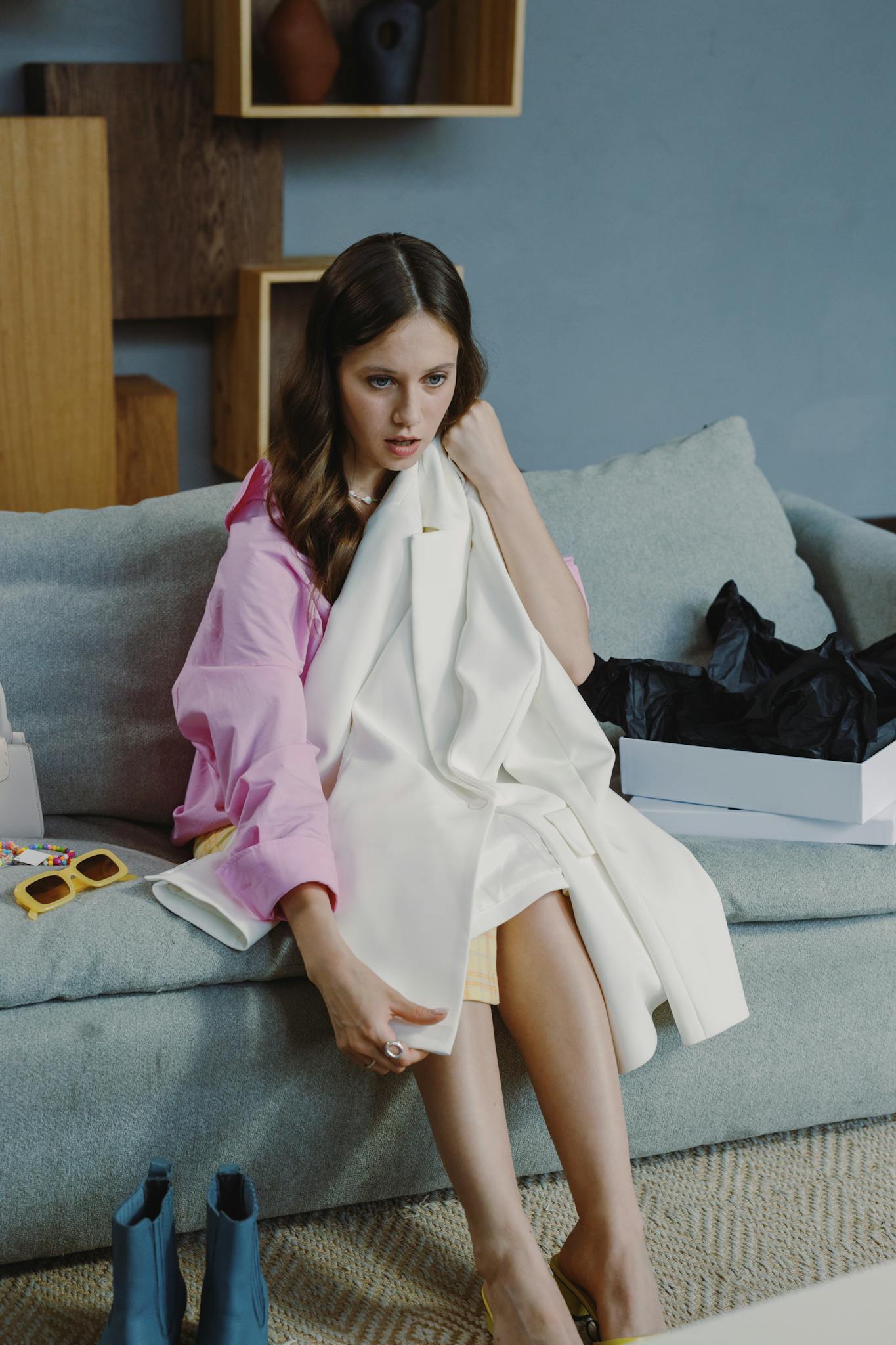 Woman in stylish outfit examining new clothing with focus on fashion and style.